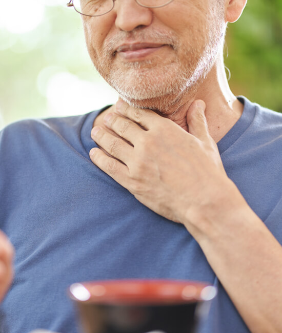 A man touching his throat