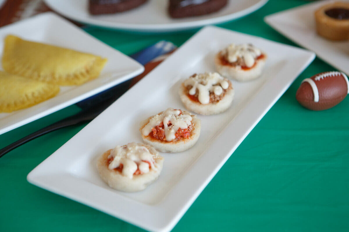 Dysphagia-friendly pizza bites on white plate with mini footballs